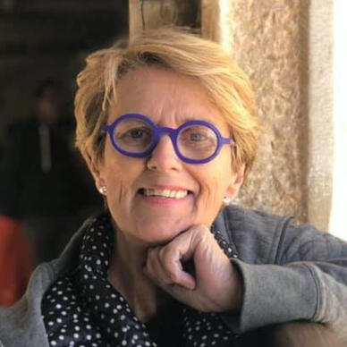 An image of Nancy Barbee wearing a pair of purple spectacles